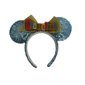 NWOT Disneyland Marquee Sky Blue Ear headband blue sequins featuring yellow bow